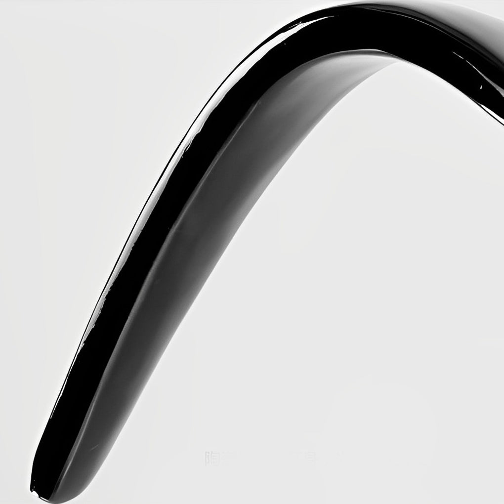 Close-up of curved wing-shaped light arm in glossy black finish.