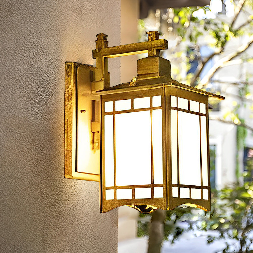 Lantern wall sconce with wooden frame and frosted glass panels beside green plants.