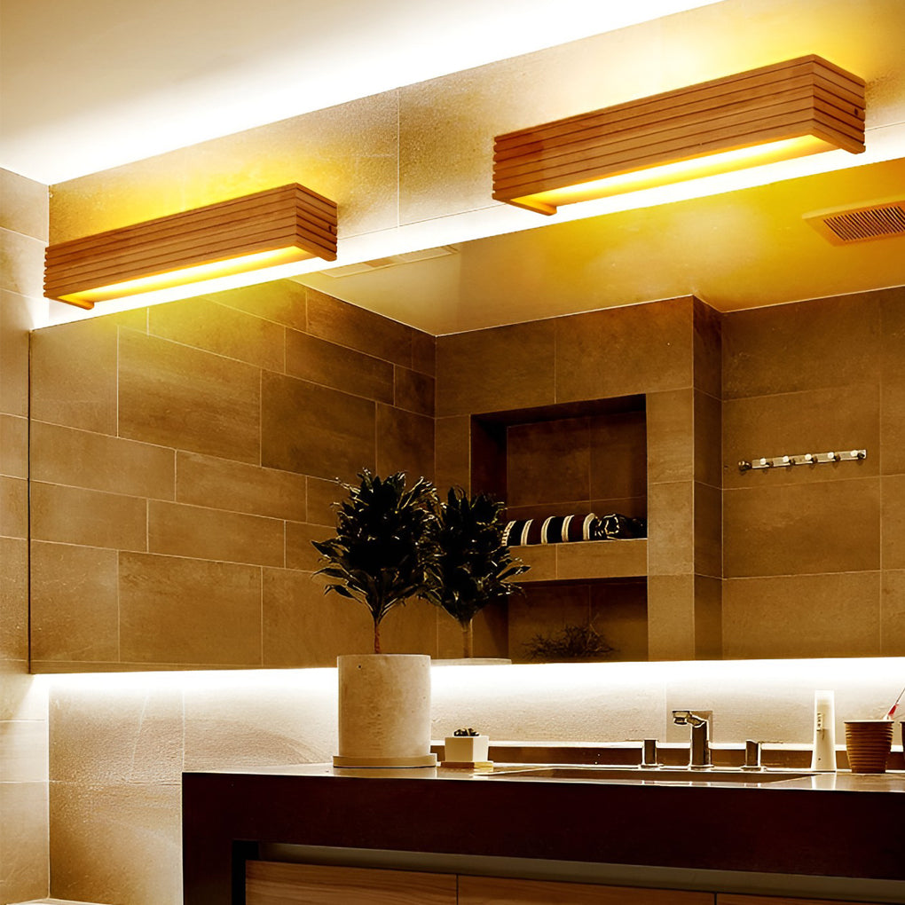 Wooden wall lamp installed above a bathroom mirror, providing soft indirect lighting for a spa-like feel.