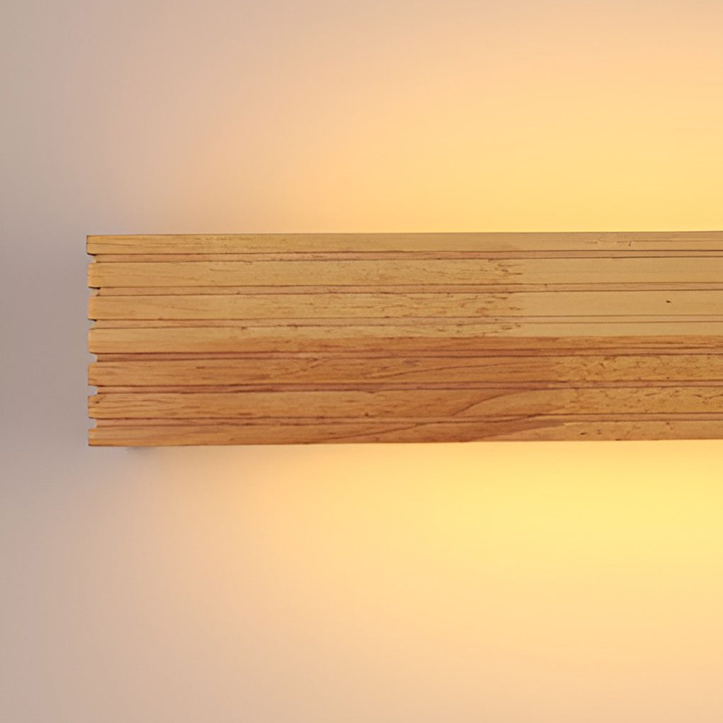 Wooden wall lamp front view highlighting linear design and warm LED glow against a neutral wall.