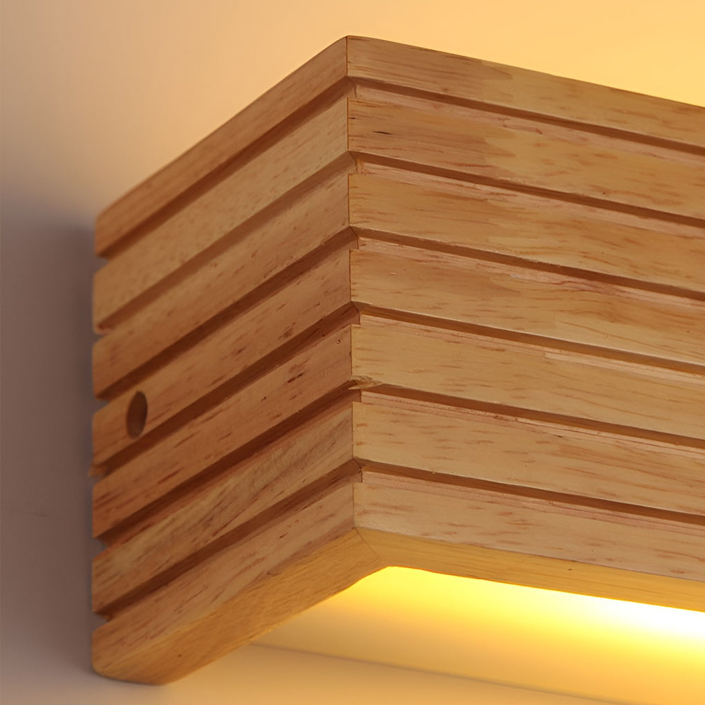 Wooden wall lamp side angle detail displaying stacked wood layers and downward light emission.
